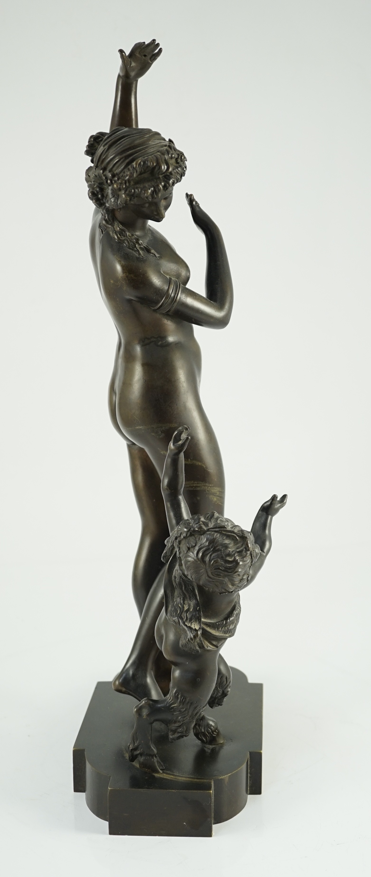 A 19th century French bronze group of a muse dancing alongside a faun, 24cm wide, 52cm high